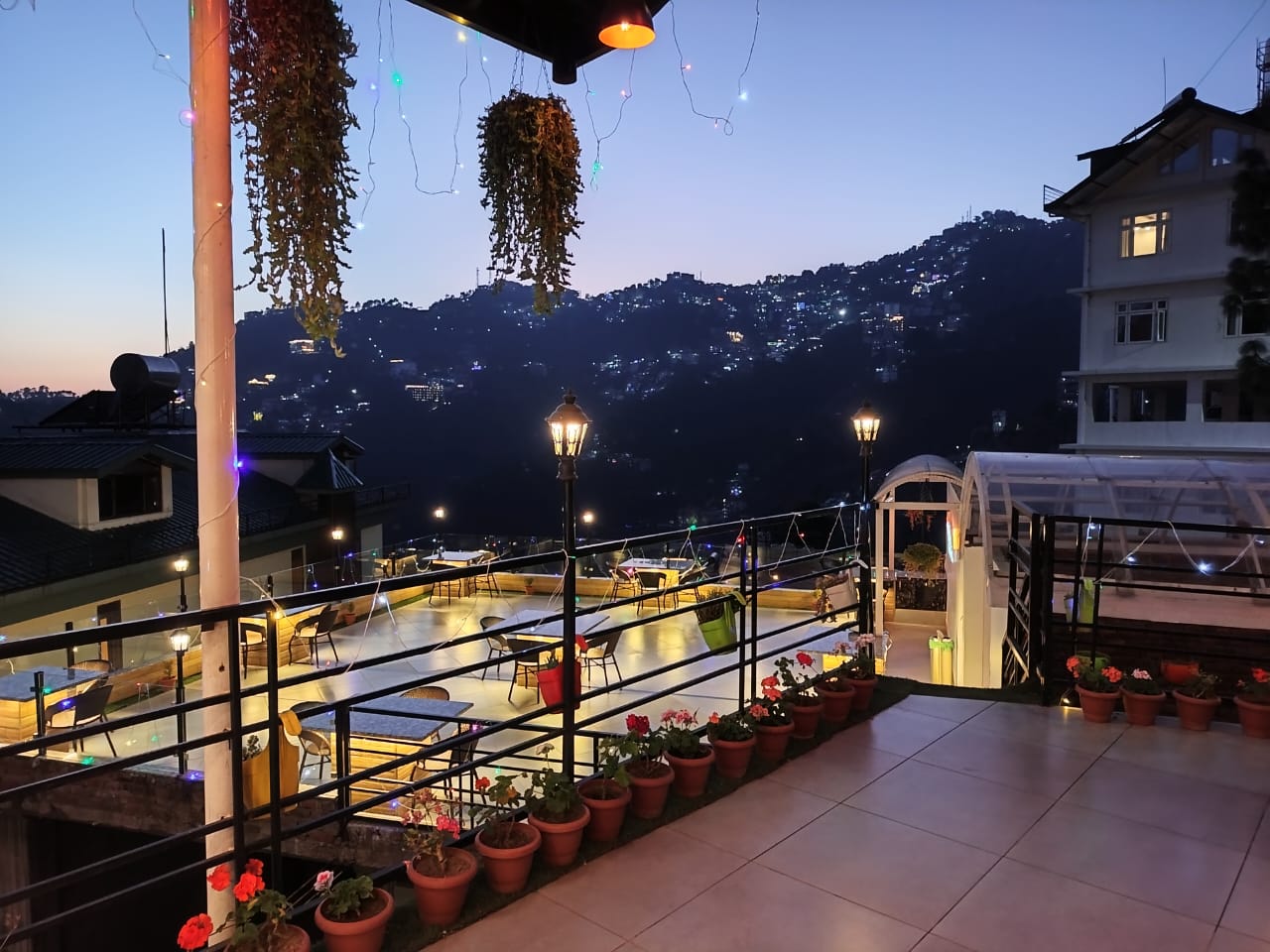 Rooftop terrace at dusk with valley views